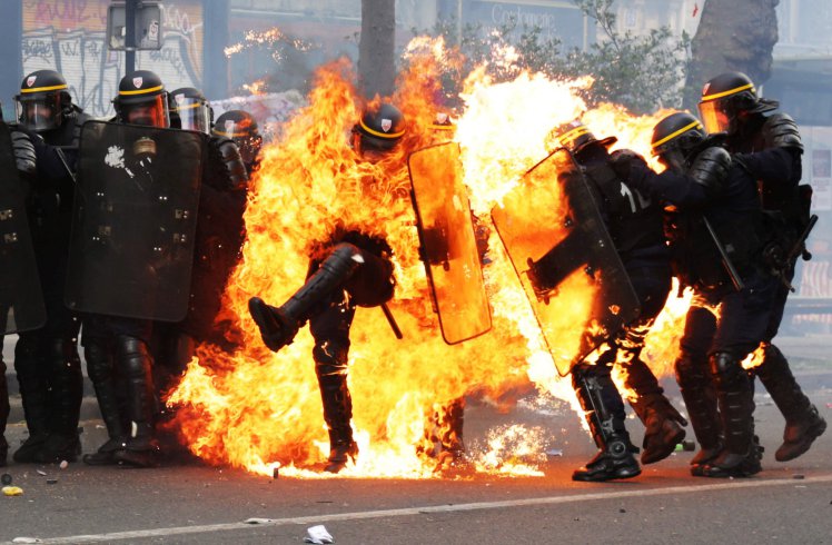 French CRS anti-riot police officers are engulfed in flames as they face protesters during a march for the annual May Day workers' rally in Paris on May 1, 2017. / AFP PHOTO / Zakaria ABDELKAFIZAKARIA ABDELKAFI/AFP/Getty Images